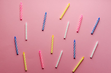  multicolored candles for cake on paper background