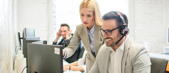 Business woman giving instructions to male employee at workplace