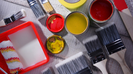 Paintbrushes of different size and paint can