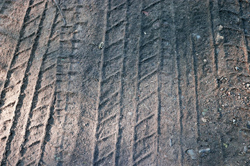 Tyre tracks on sand in brown tone. Abstract background and pattern.