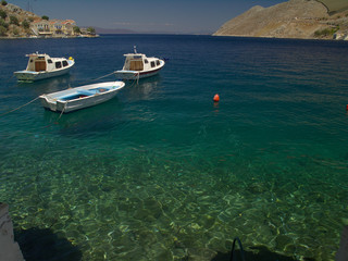 Obraz premium Simi island port, Greece. Summer day view to traditional greek island port with boats.