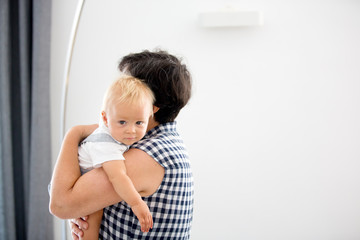Fototapeta premium Grandmother holding happy baby at home