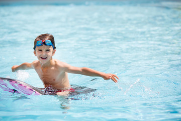 Fototapeta na wymiar Kdis, jump in water pool on holiday, family vacation