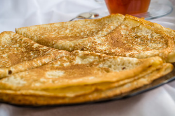Russia, Severodvinsk, a stack of homemade Russian pancakes in the form of a triangular envelope, selective focus