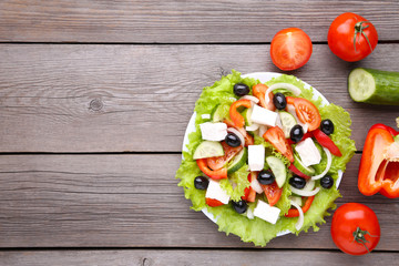 Fresh vegetable salad on grey background