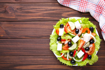 Fresh vegetable salad on brown background