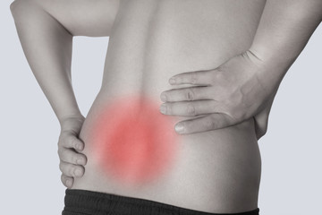 A man bending over shows a spot of back pain. Medical concept.