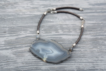 Ornament with an agate cut on a leather lace
