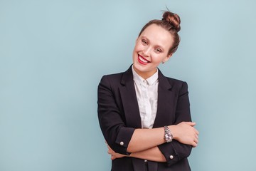 Portrait of office worker girl in classic suit with red lips isolated indoors on blue background