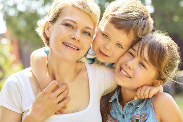 portrait of a family outdoors. mom with children in the summer. Mother and kids