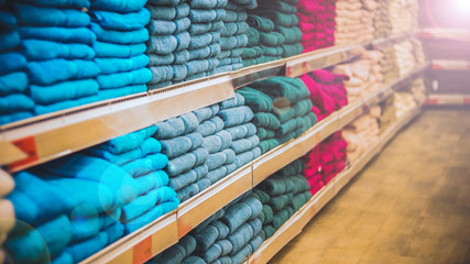 Shelves store with colorful towels and linens.