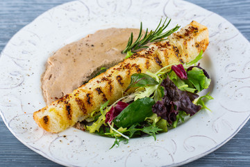 Chicken paste, is served with greens and garlick small loaf