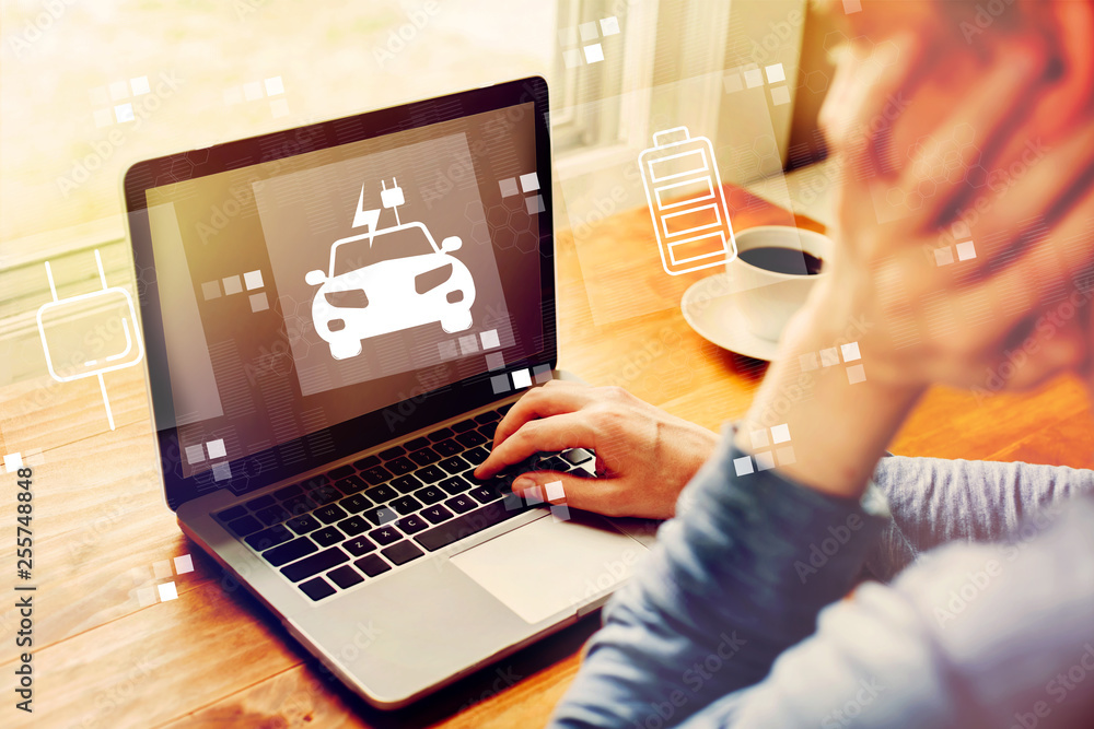 Poster ev with man using a laptop computer