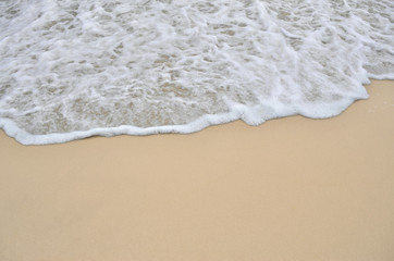 Fototapeta na wymiar Tidal wave on a clean, sandy, sea beach