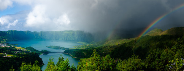 The Azores, Portugal. Sudden change of weather at sete cidades at sao miguel island causes a double rainbow. the azores are known to have 4 seasons during a day. 