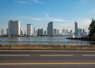 City view from the bridge over the river and the blue sky background