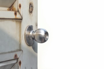 close-up opening old steel door with metal door knob isolate on white background, copy space of text