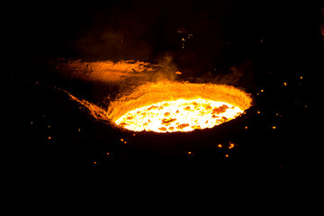 metal casting process with red high temperature fire in metal part factory