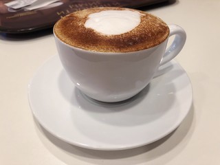 Delicious cappuccino with cinnamon in the cafe 