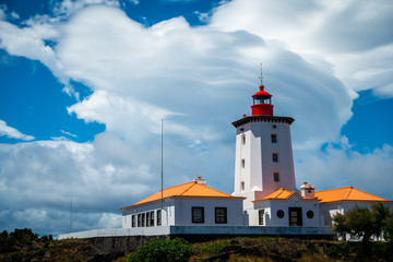 Fototapeta na wymiar beautiful lenticular cloud above a lighthouse on the island of Pico, the Azores