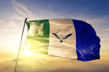 Principe Province flag waving on the top sunrise mist fog