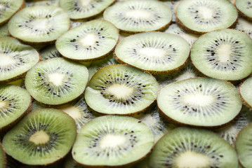 Kiwi slices background. Slices of ripe kiwi. Kiwi background