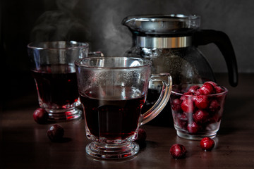 Fruit tea. Glass cups and teapot filled with cherry tea - Powered by Adobe