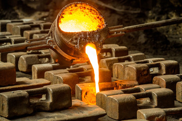 metal casting process with red high temperature fire in metal part factory