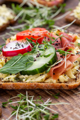 Sandwiches with cream cheese, vegetables and salami.