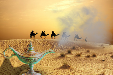 Magic genie lamp on sand dunes with camel ride caravan traveling  in Arabian Desert - obrazy, fototapety, plakaty
