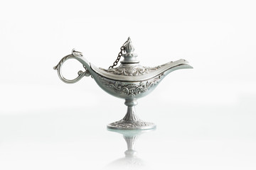 Silver genie lamp isolated on white background