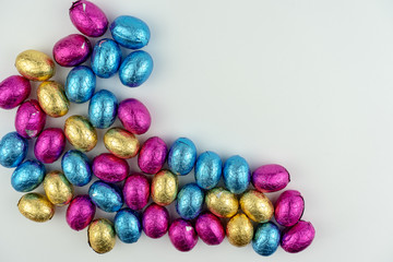 Group of easter eggs in blue, yellow and pink