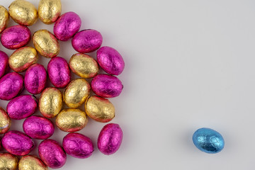 Group of easter eggs in blue, yellow and pink