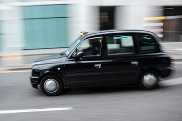 Black cab taxi  in motion on the street in Central London