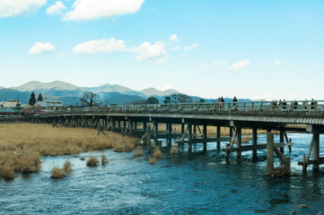 People cross the famous Togetsukyo bridge in Arashiyama/Togetsukyo bridge in Arashiyama prefecture...