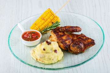 The slightly smoked chicken, is served with potatoes, popcorn and sauce