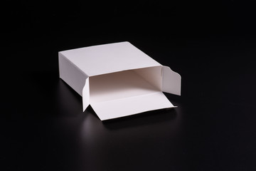 white cardboard box on black background, moke up