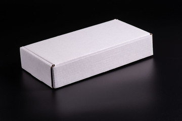 white cardboard box on black background, moke up