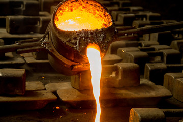metal casting process with red high temperature fire in metal part factory