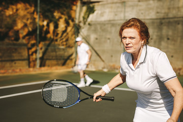 Senior woman playing tennis