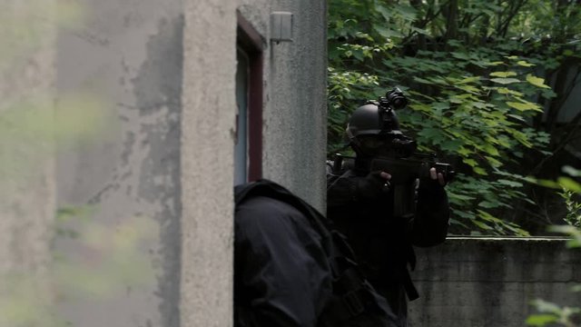 Specila Force Team stand beside a rustical house