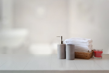 Fototapeta na wymiar Ceramics shampoo or soap, Towels on top marble counter with copy space on bathroom background.