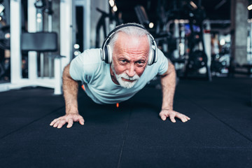 Fototapeta premium Senior man exercising at gym.