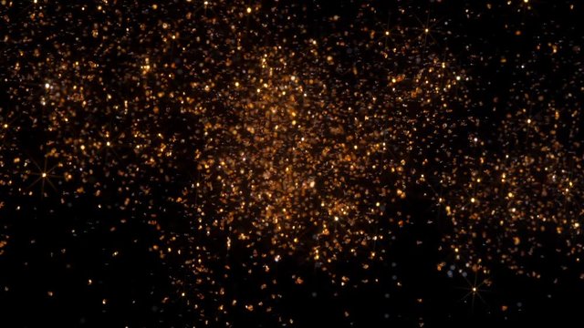 Abstract golden background with shining bokeh sparkling particles. Christmas gold light, celebration concept. Universe gold dust with stars on black