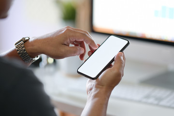 Cropped shot businessman using mobile phone