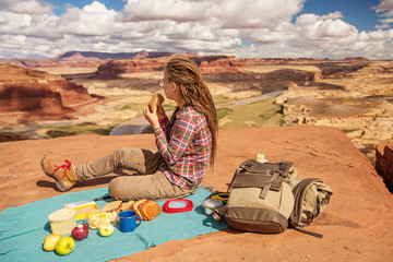 Happy mother and son having picnic while travel in nature