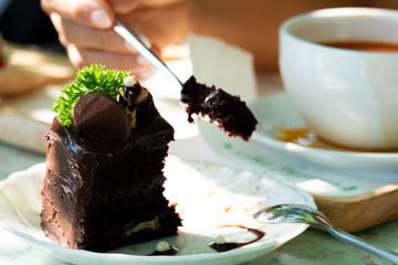 Eating chocolate cake with spoon.