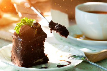 Eating chocolate cake with spoon.