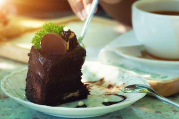 Eating chocolate cake with spoon.
