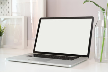 Mockup laptop on white wood workspace.